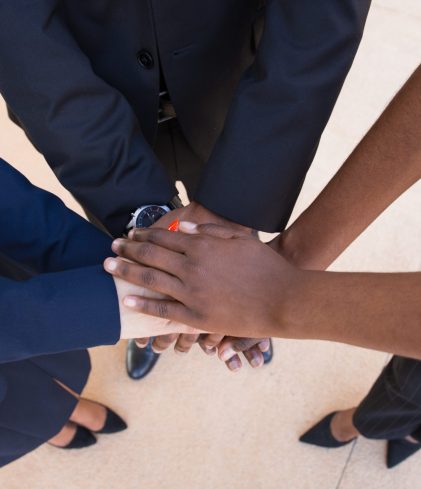 Teamwork, support or friendship gesture. Stack of hands of mix raced business professionals. United team concept